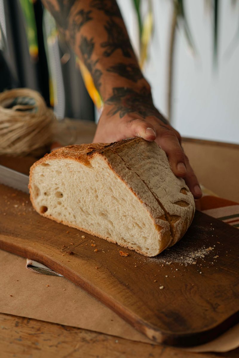 Sliced artisan sourdough loaf on a wooden cutting board.